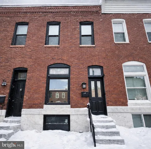 a front view of a brick building with many windows