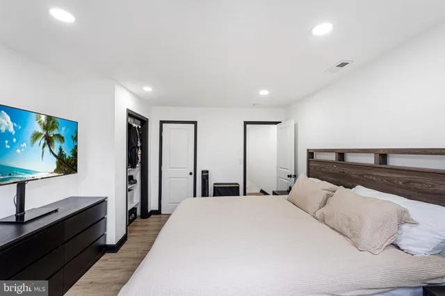 a bedroom with a bed and a flat screen tv