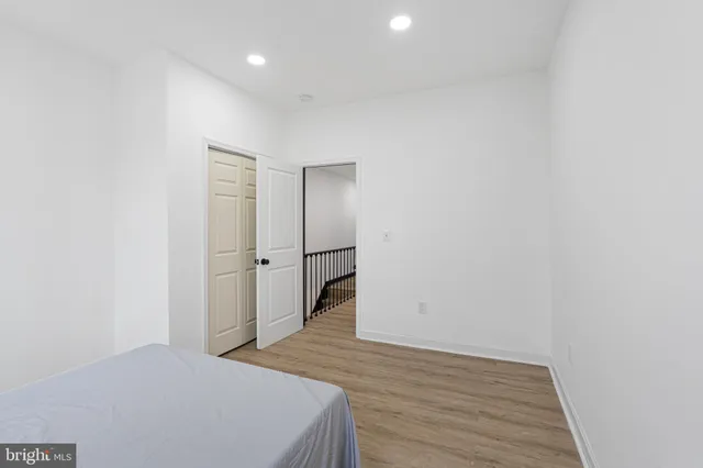 a view of a room with wooden floor and white walls