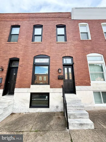a front view of a brick building with many windows