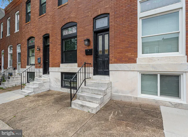 a front view of a house with large windows