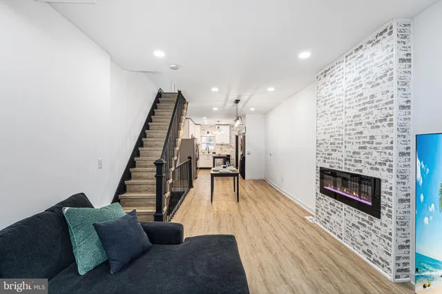 a living room with furniture and a fireplace
