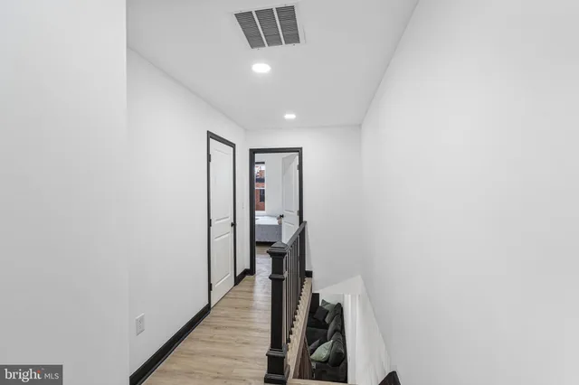 a view of hallway with wooden floor