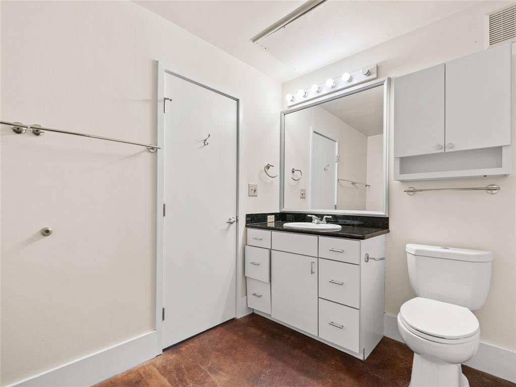 911 Keith Lane, Unit 12 Austin, TX 78705 - Photo 11 of 16 a bathroom with a granite countertop sink toilet and shower