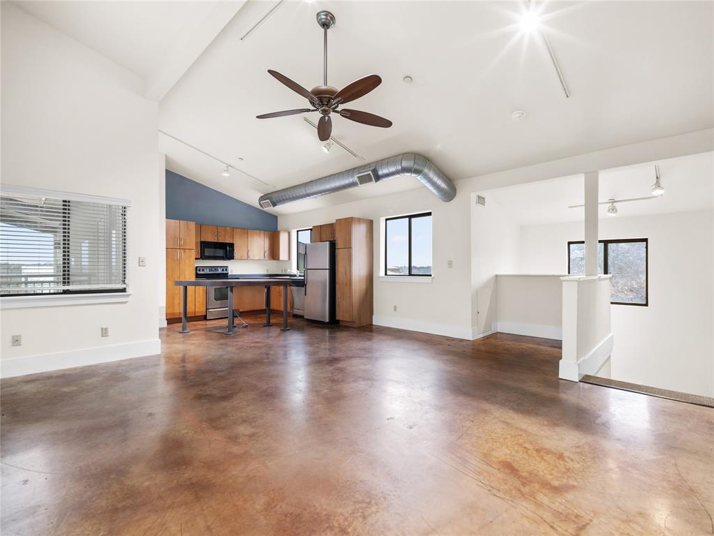 911 Keith Lane, Unit 12 Austin, TX 78705 - Photo 2 of 16 a view of an empty room with a window and wooden floor