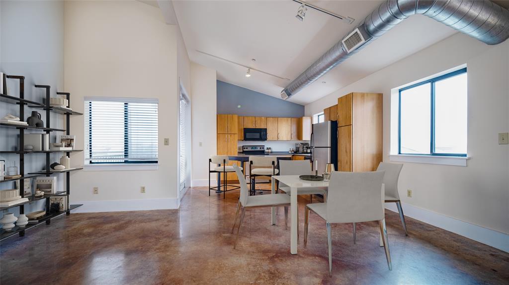 911 Keith Lane, Unit 12 Austin, TX 78705 - Photo 3 of 16 a view of a dining room with furniture and a window