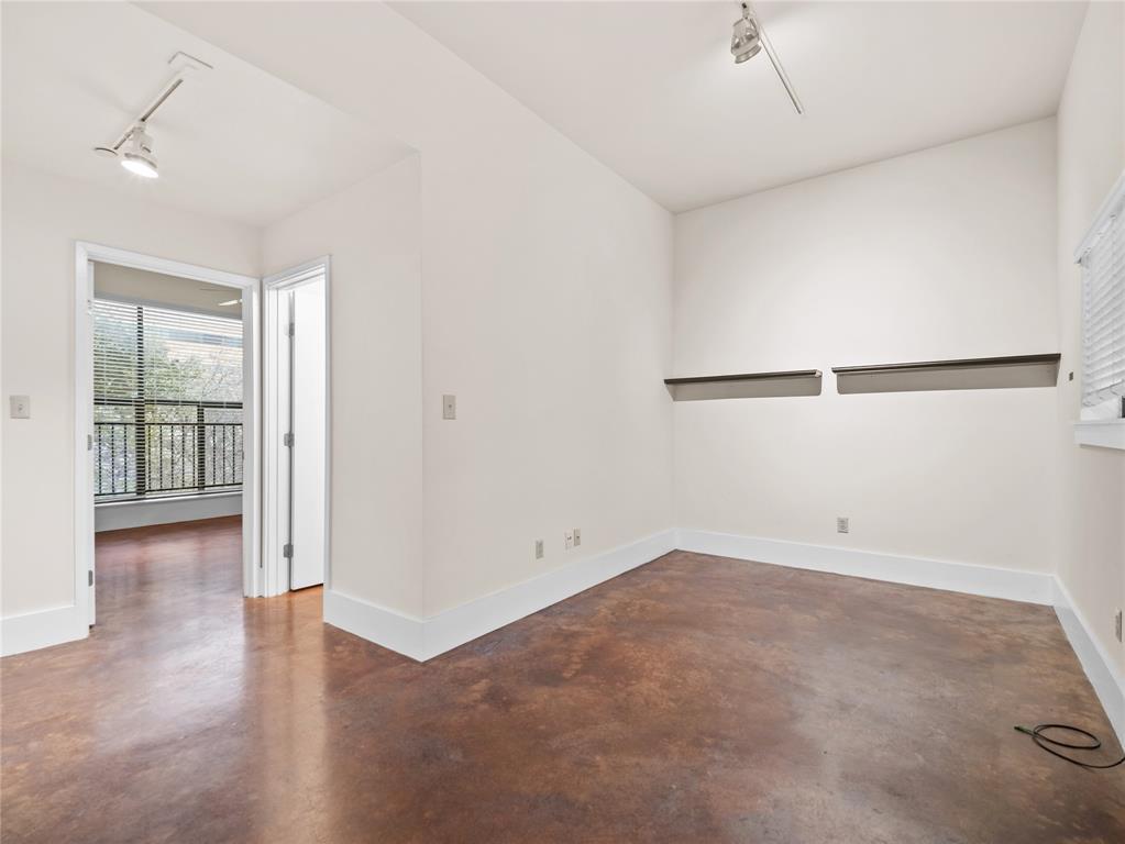 911 Keith Lane, Unit 12 Austin, TX 78705 - Photo 7 of 16 wooden floor in an empty room with a window
