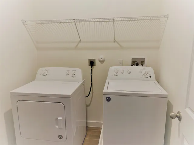 a bathroom with a granite countertop bathtub shower sink vanity and toilet