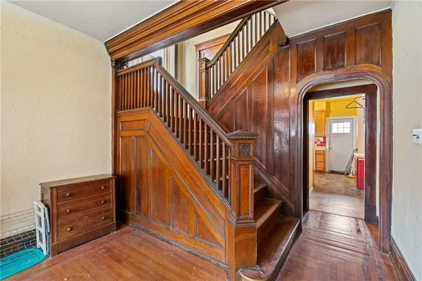 a view of entryway and hall with wooden floor