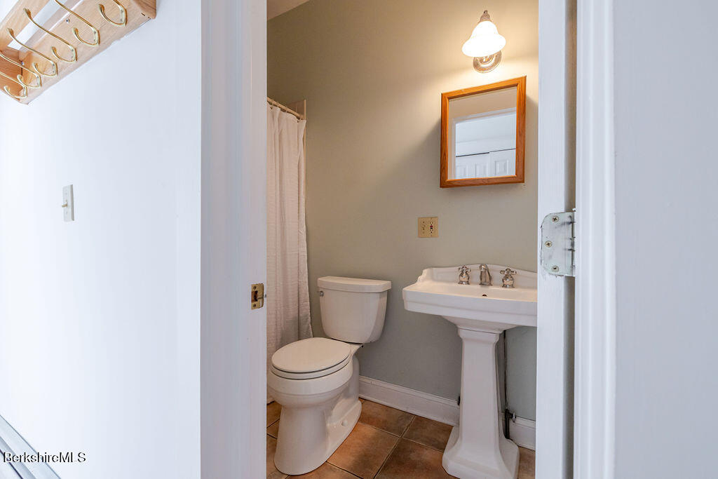3 Townhouse Hill Road Egremont, MA 01230 - Photo 15 of 39 a white toilet sitting next to a bathroom sink