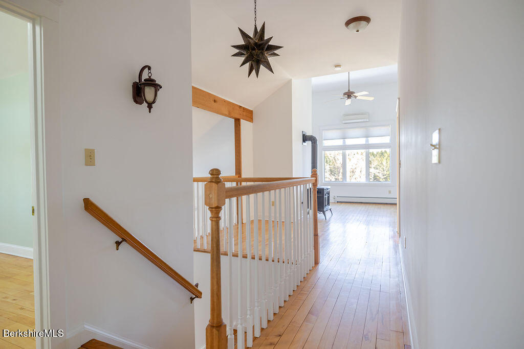 3 Townhouse Hill Road Egremont, MA 01230 - Photo 16 of 39 a view of a hallway with wooden floor and a chandelier