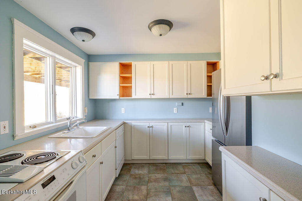3 Townhouse Hill Road Egremont, MA 01230 - Photo 32 of 39 a kitchen with a sink a window and cabinets