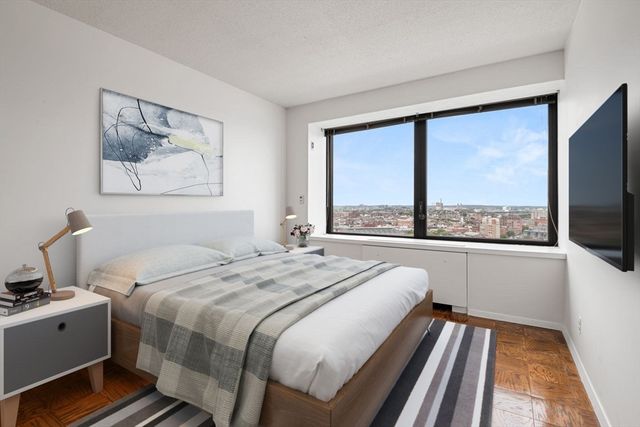 a bed sitting in a bedroom next to a window