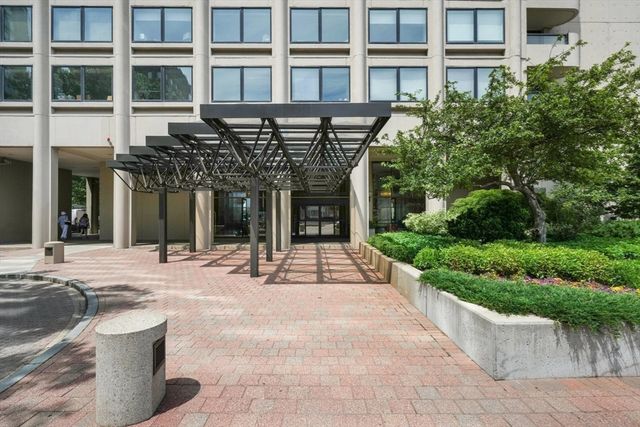 a front view of a building with a garden