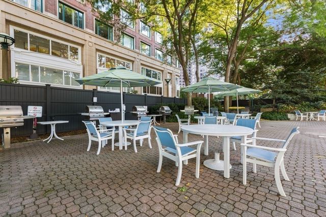 a view of a patio with a table and chairs under an umbrella