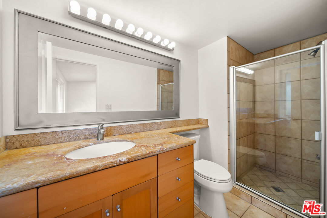 27041 Whitestone Road Rancho Palos Verdes, CA 90275 - Photo 20 of 23 a bathroom with a granite countertop sink mirror vanity and toilet