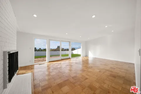 a view of an empty room with glass door
