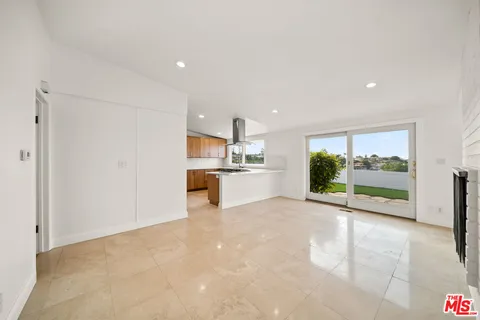 a view of a kitchen with a sink and a large window