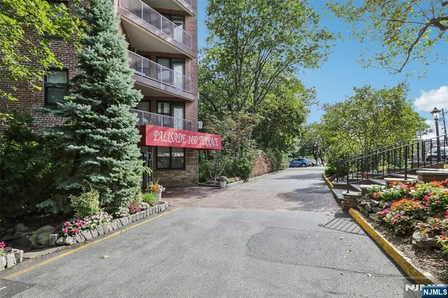 a street sign on a sidewalk next to a road