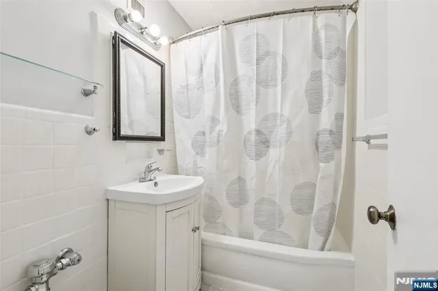 a bathroom with a sink a mirror and a bathtub