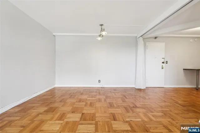 a view of an empty room with a ceiling fan
