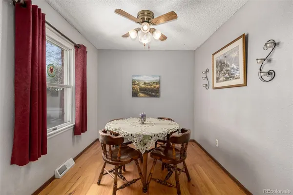 a view of a dining room with furniture and a chandelier
