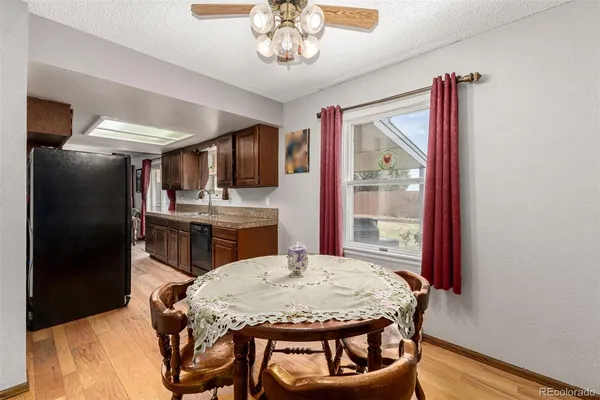 a view of a dining room with furniture and a chandelier