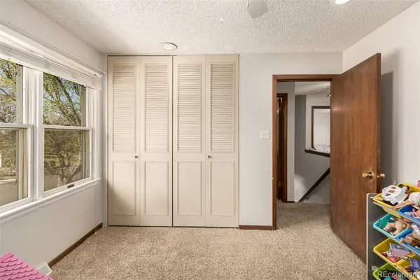 an empty room with windows and closet