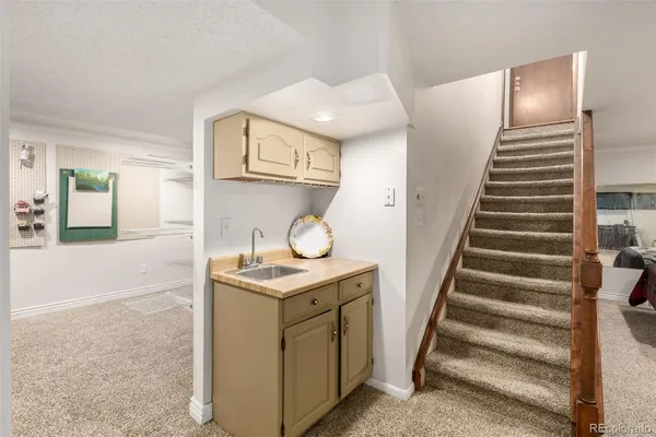 a view of hallway with stairs and wooden floor