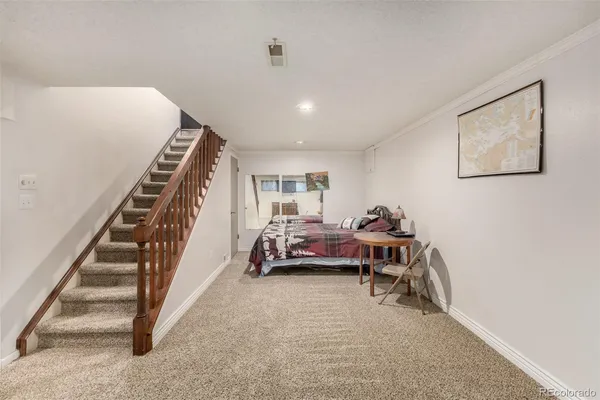 a bedroom with furniture and a window