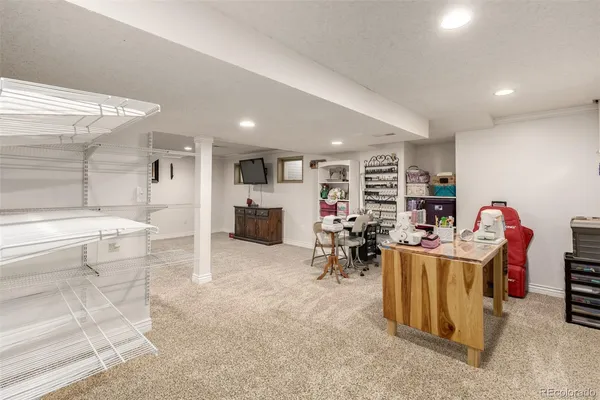 a living room with lots of furniture and clutter