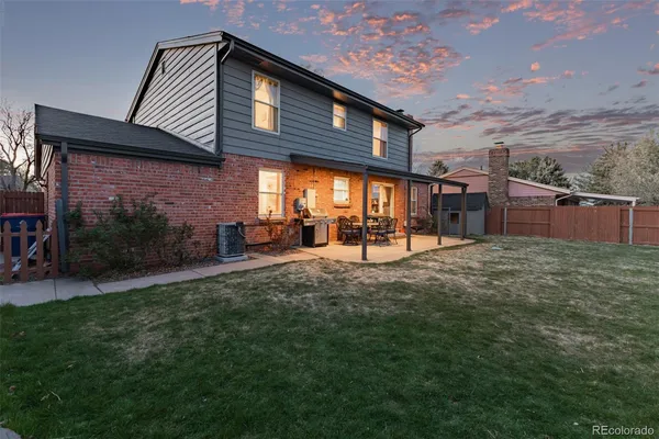 a backyard of a house with table and chairs