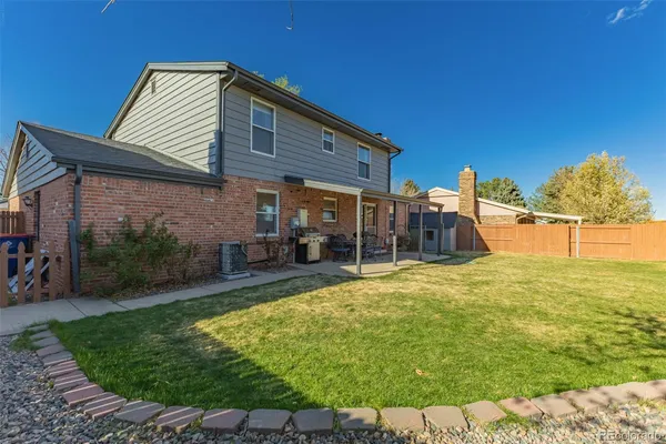 a backyard of a house with yard and outdoor seating