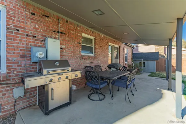 a patio with table and chairs