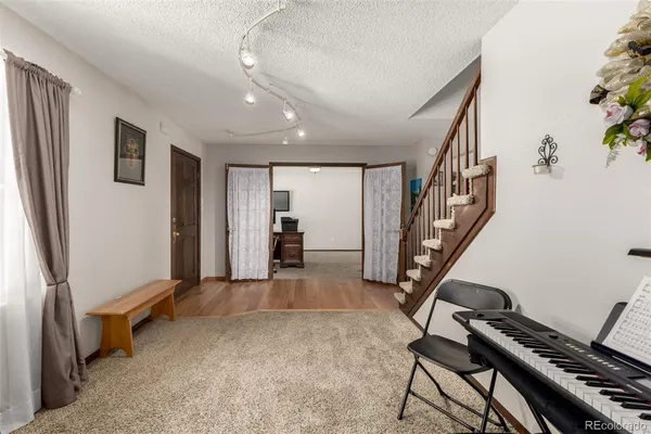 a view of an empty room with wooden floor