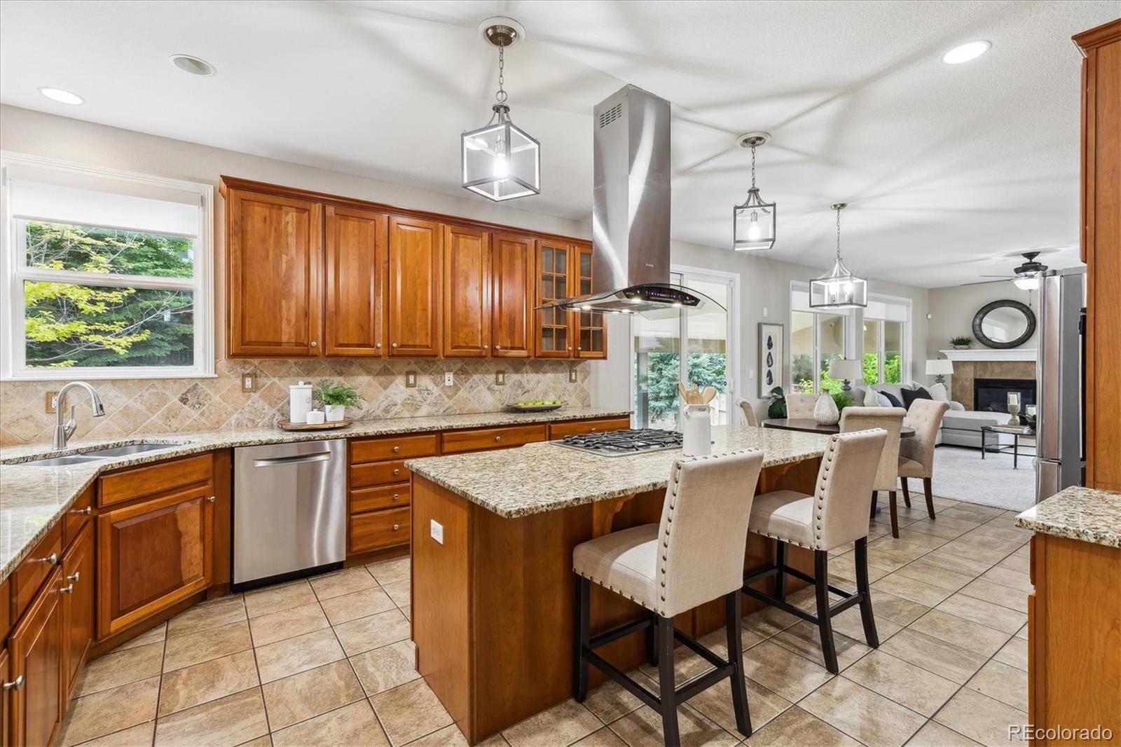 2601 Pemberly Avenue Highlands Ranch, CO 80126 - Photo 12 of 38 a kitchen with a table chairs sink and cabinets