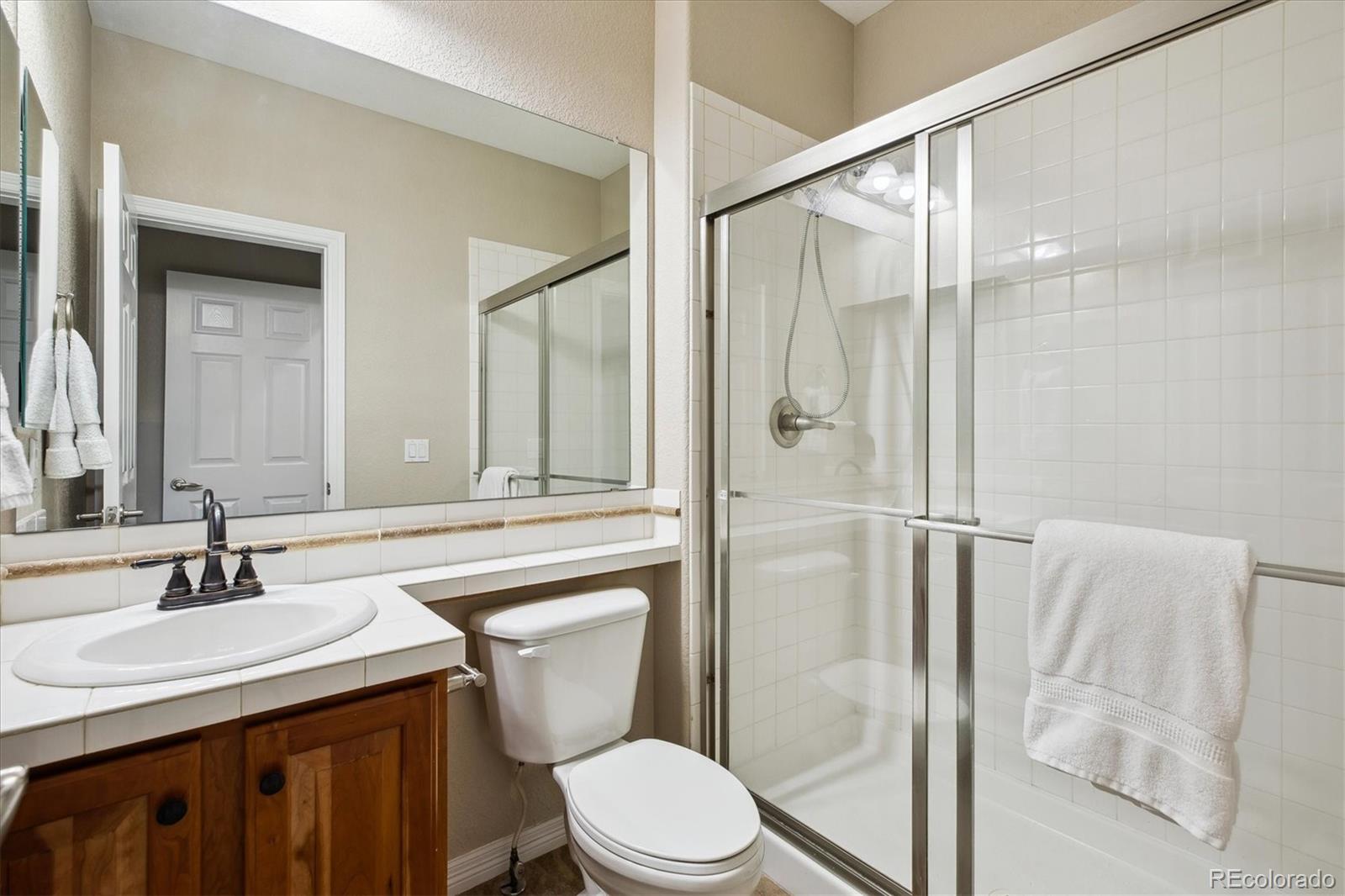 2601 Pemberly Avenue Highlands Ranch, CO 80126 - Photo 26 of 38 a bathroom with a sink toilet and shower