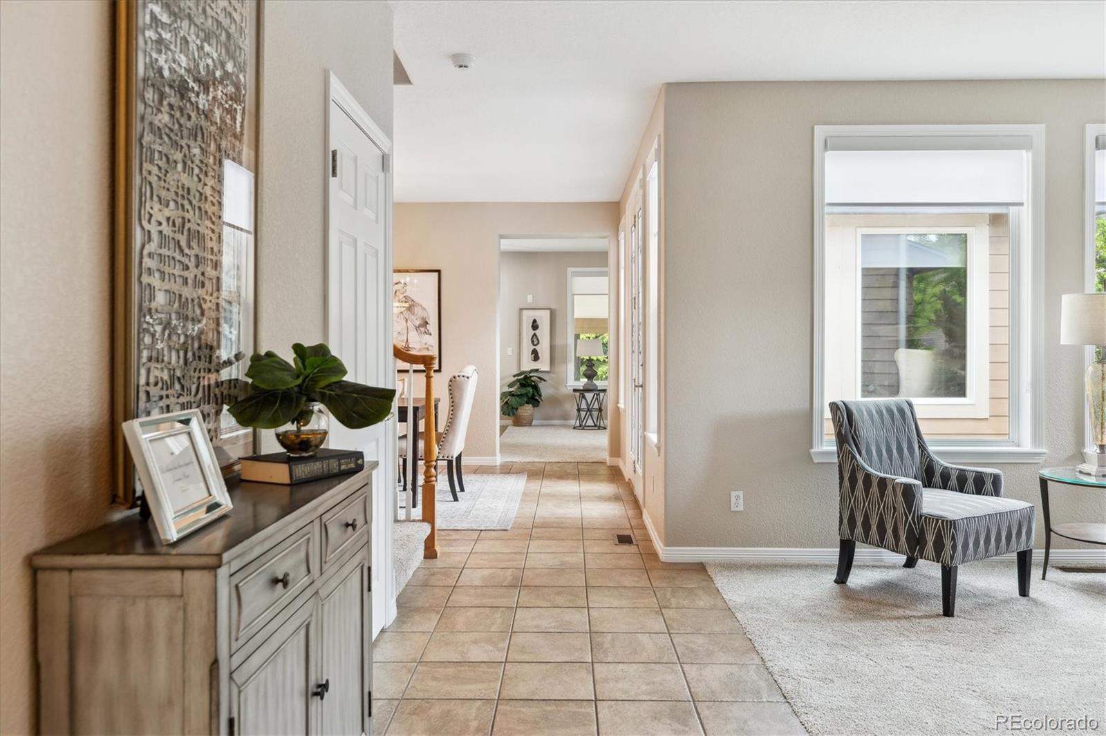 2601 Pemberly Avenue Highlands Ranch, CO 80126 - Photo 5 of 38 a dining room with furniture and a potted plant