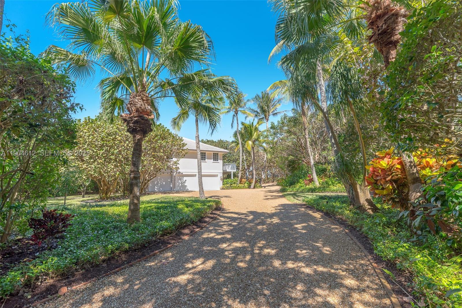 247 South Beach Road Jupiter Island, FL 33455 - Photo 13 of 71 a view of a yard with plants and trees