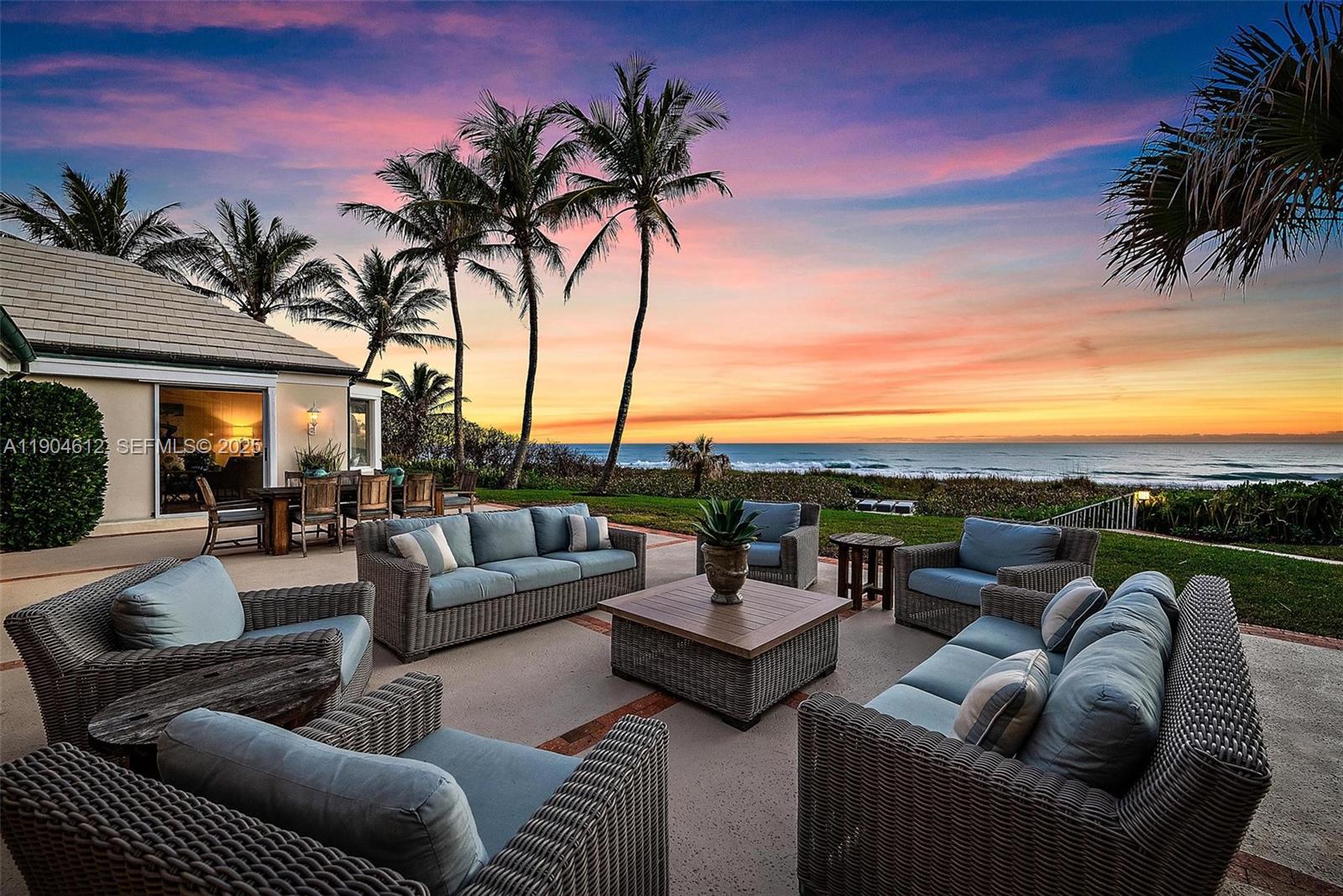 247 South Beach Road Jupiter Island, FL 33455 - Photo 2 of 71 a view of a patio with couches and a fire pit