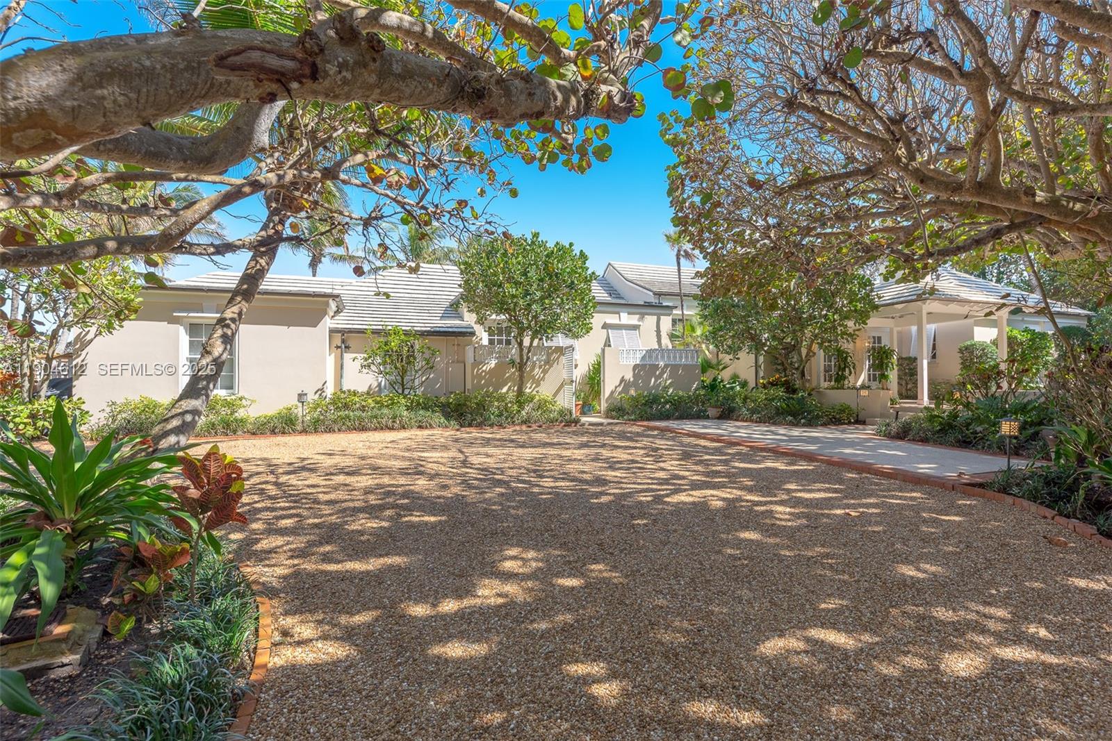 247 South Beach Road Jupiter Island, FL 33455 - Photo 23 of 71 a front view of a house with a yard and garage