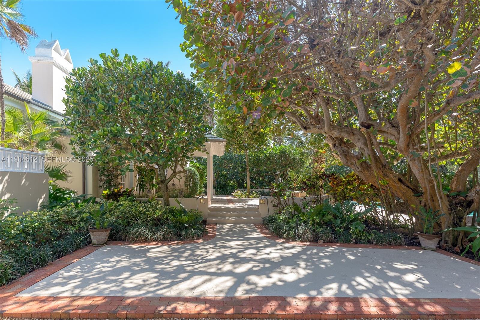 247 South Beach Road Jupiter Island, FL 33455 - Photo 24 of 71 a view of a street with trees and bushes