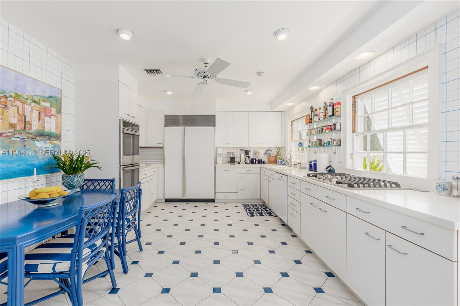 247 South Beach Road Jupiter Island, FL 33455 - Photo 37 of 71 a kitchen with stainless steel appliances kitchen island granite countertop a sink a stove a dining table and chairs