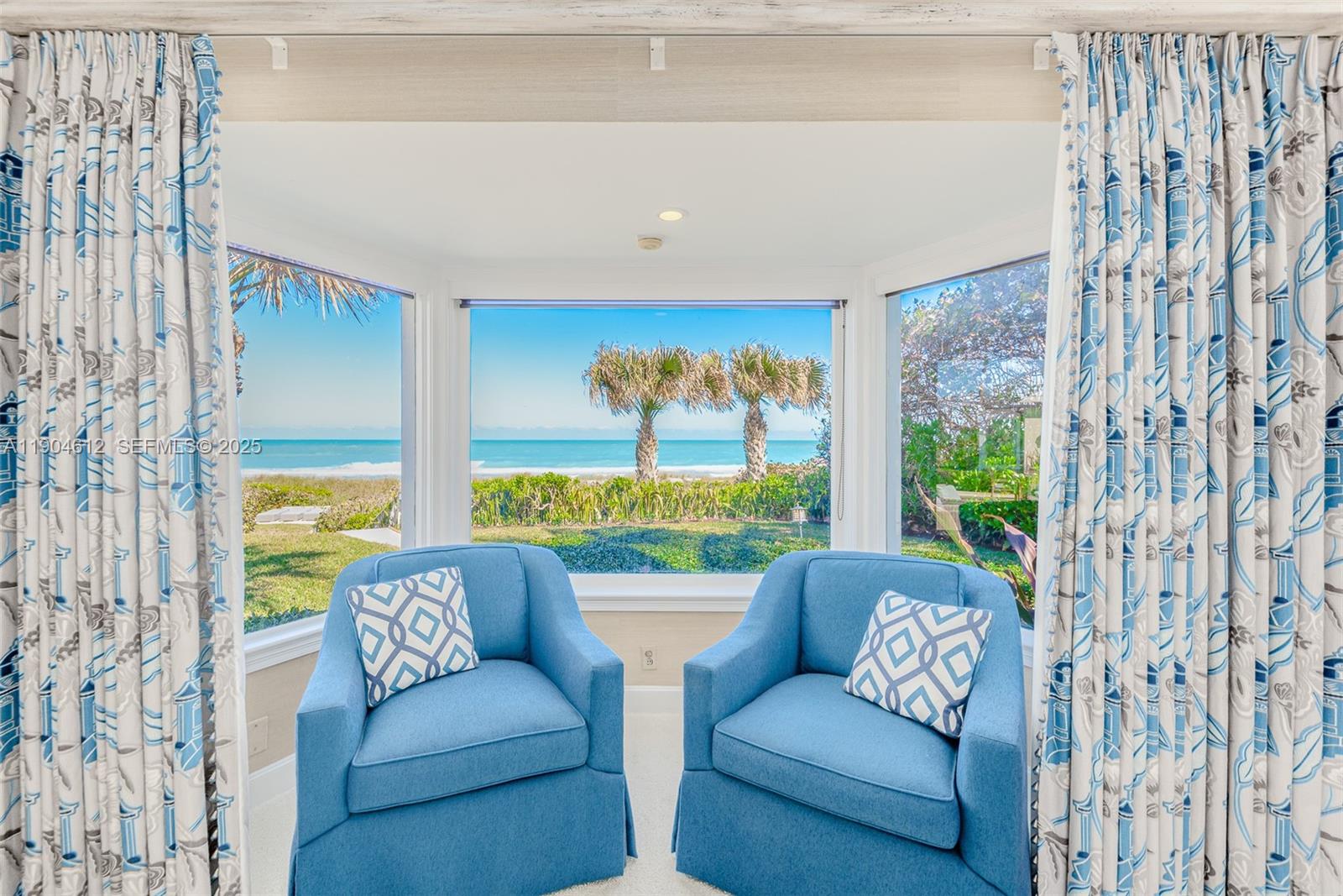 247 South Beach Road Jupiter Island, FL 33455 - Photo 40 of 71 a living room with furniture and a large window