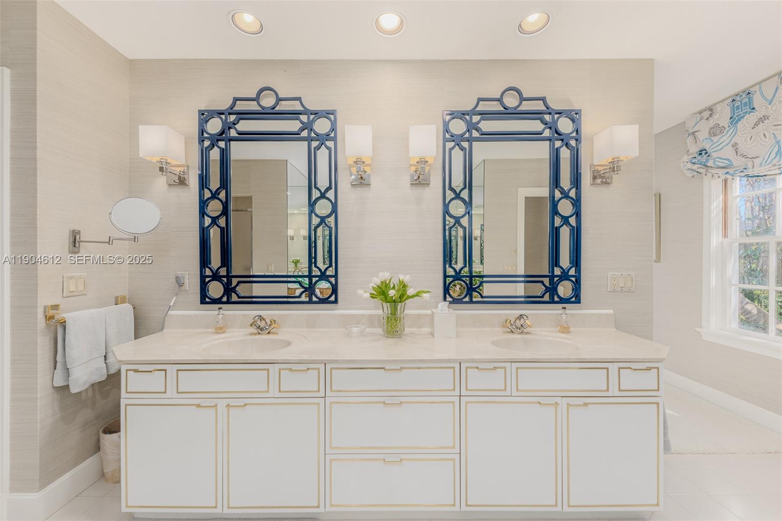 247 South Beach Road Jupiter Island, FL 33455 - Photo 42 of 71 a bathroom with double vanity sinks and a mirror