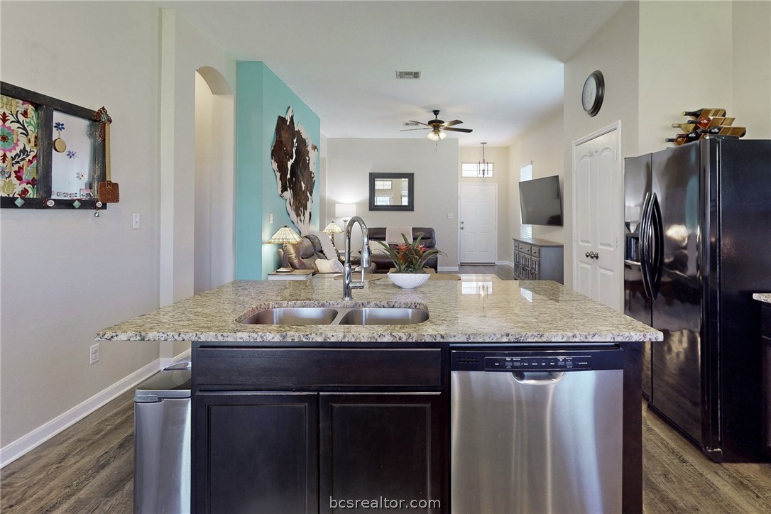 2071 Positano Loop Bryan, TX 77808 - Photo 12 of 31 a bathroom with a granite countertop sink a large mirror and a window