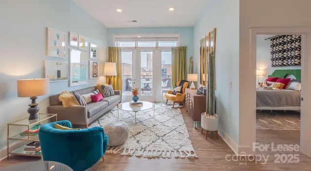 a living room with furniture and a large window