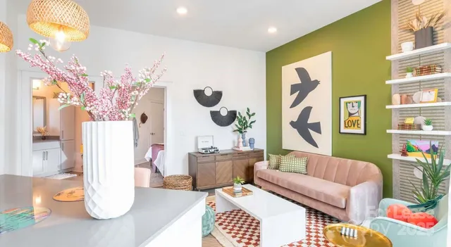 a living room with furniture and a chandelier