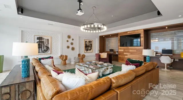 a view of a dining room with furniture a chandelier and wooden floor