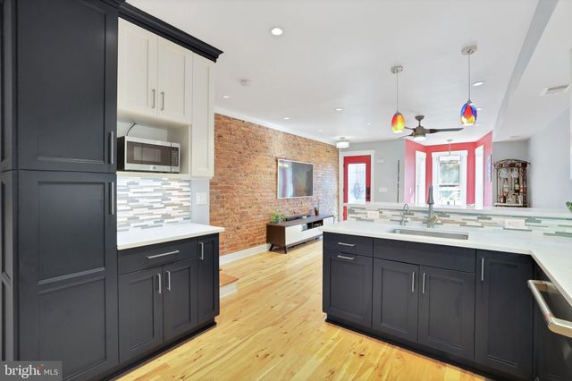 a kitchen with stainless steel appliances granite countertop a sink and wooden cabinets